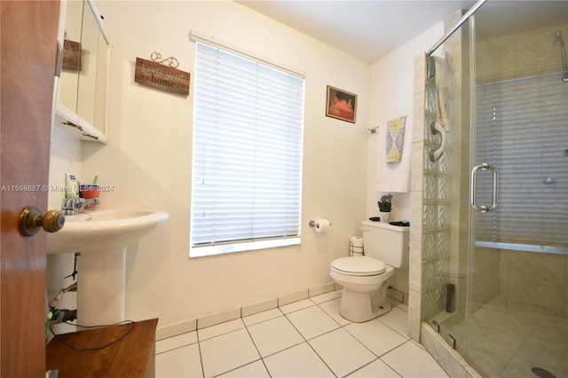 bathroom with toilet, sink, tile patterned floors, and a shower with shower door