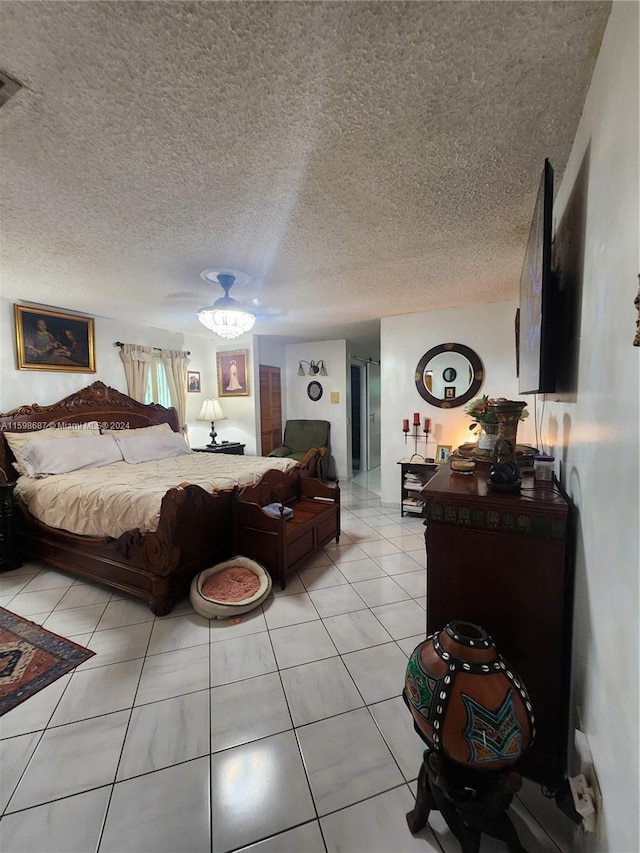 bedroom featuring light tile patterned flooring, a textured ceiling, and ceiling fan