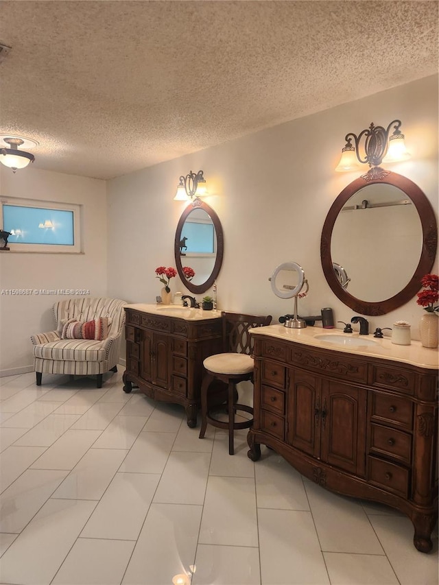 bathroom featuring tile patterned flooring, a textured ceiling, and vanity