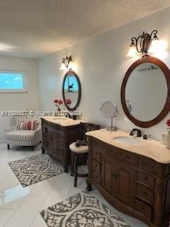 bathroom featuring vanity, tile patterned flooring, and a textured ceiling