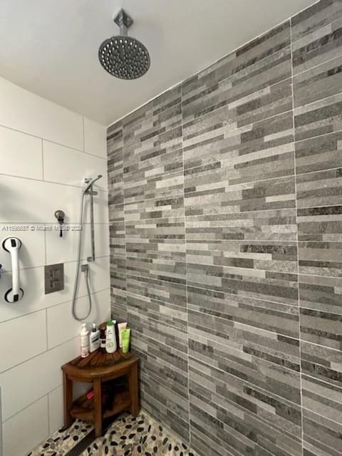 bathroom with tiled shower