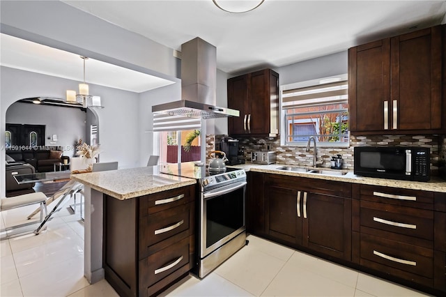 kitchen with sink, island range hood, hanging light fixtures, decorative backsplash, and stainless steel electric range