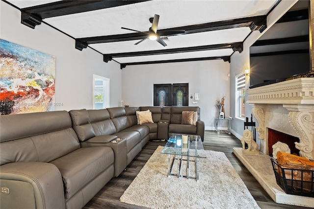 living room with ceiling fan, dark wood-type flooring, plenty of natural light, and beam ceiling