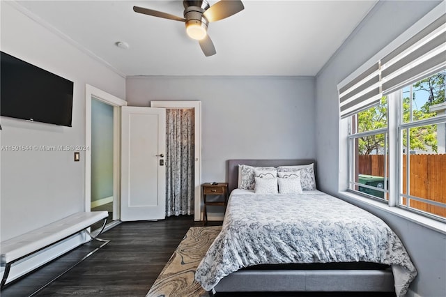 bedroom featuring a baseboard heating unit, ornamental molding, dark hardwood / wood-style floors, and ceiling fan