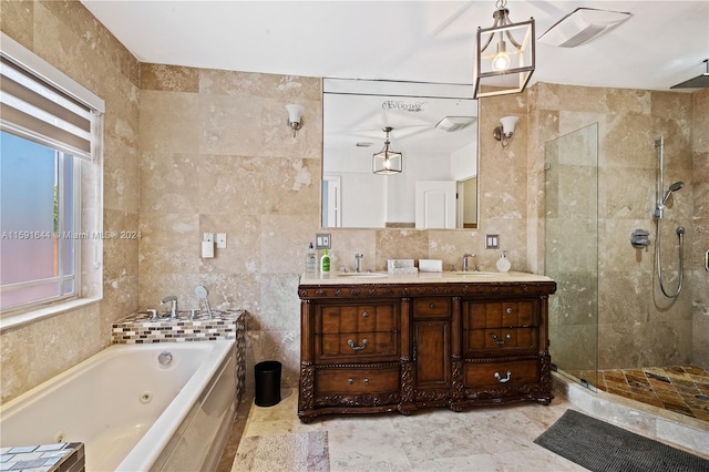 bathroom featuring tile walls, vanity, and separate shower and tub