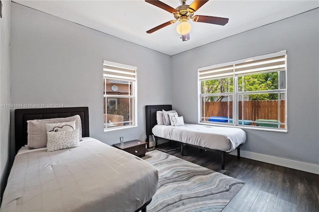 bedroom featuring ceiling fan and dark wood-type flooring