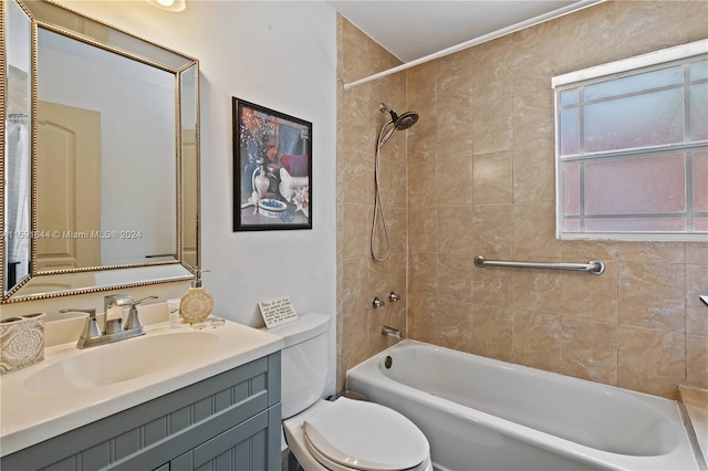 full bathroom with vanity, tiled shower / bath, and toilet