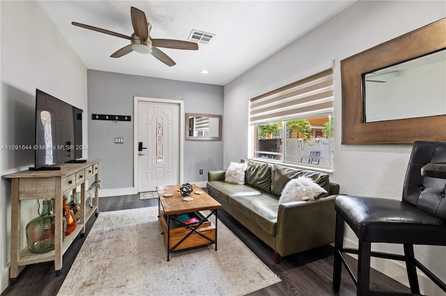 living room with ceiling fan and dark hardwood / wood-style flooring