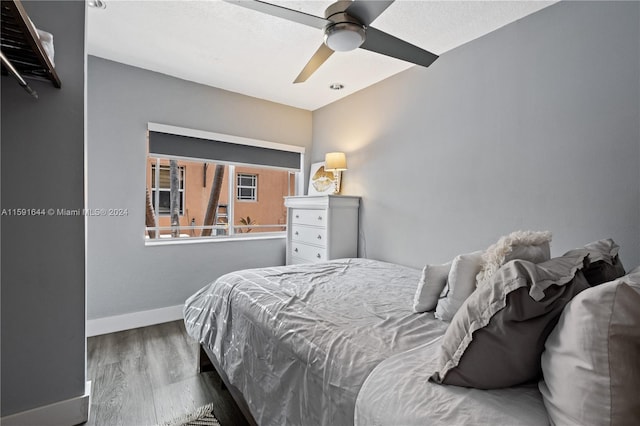 bedroom with ceiling fan and wood-type flooring