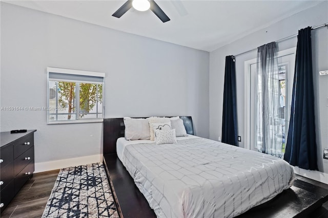 bedroom with ceiling fan and dark hardwood / wood-style floors