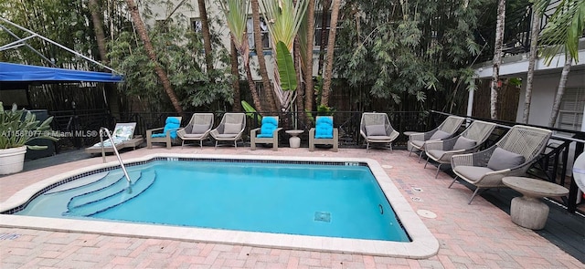 view of swimming pool with a patio area