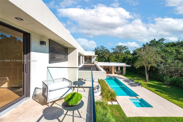 view of pool with a patio area and a yard