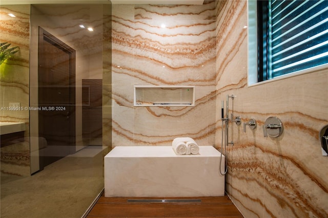 bathroom with a shower and hardwood / wood-style floors