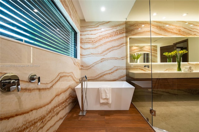 bathroom featuring separate shower and tub, vanity, and hardwood / wood-style flooring