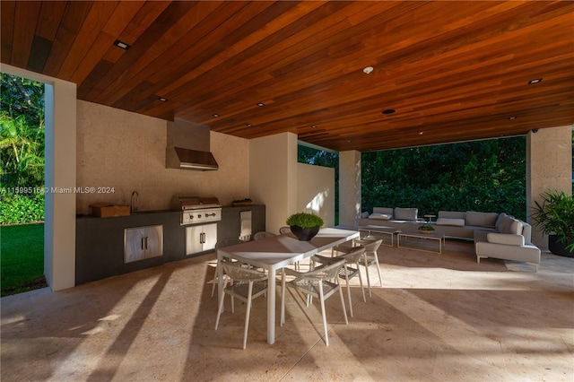 view of patio featuring grilling area, an outdoor living space, and exterior kitchen