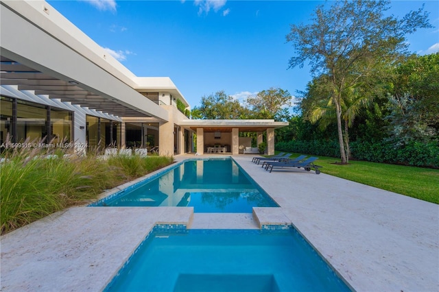 view of swimming pool with an in ground hot tub and a patio