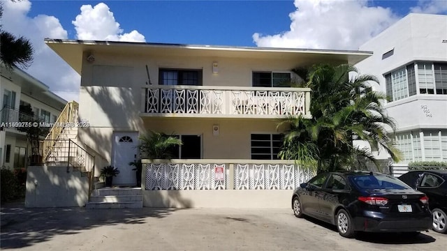 view of front of home with a balcony