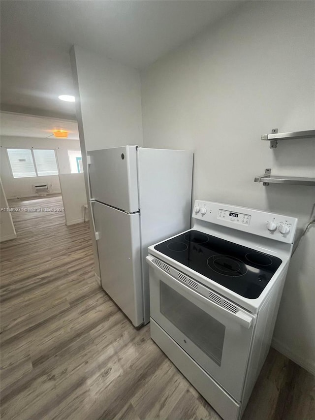 kitchen featuring white electric range oven and hardwood / wood-style floors