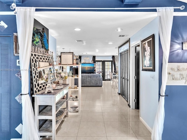 hallway with light tile patterned floors and french doors