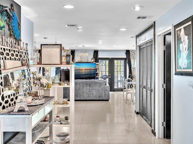 interior space featuring light tile patterned floors and french doors