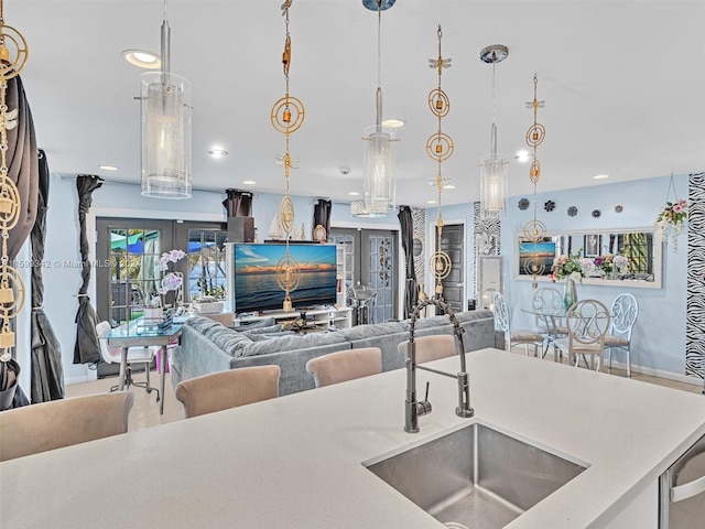 kitchen featuring decorative light fixtures, sink, and french doors