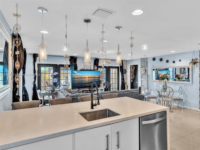 kitchen featuring french doors, white cabinets, sink, pendant lighting, and dishwasher