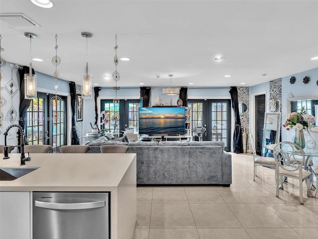 kitchen with dishwasher, french doors, hanging light fixtures, and sink