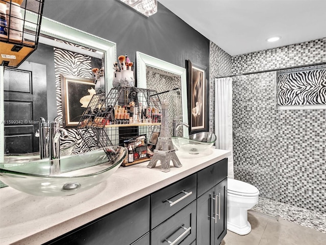 bathroom featuring tile patterned flooring, vanity, curtained shower, and toilet