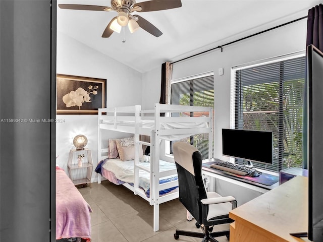 tiled bedroom with ceiling fan and vaulted ceiling