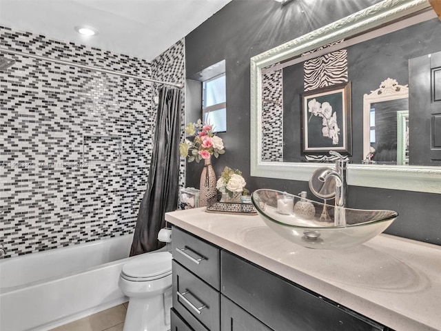 full bathroom featuring tile patterned floors, vanity, toilet, and shower / tub combo