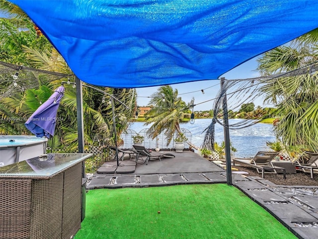 view of yard with a water view and a patio