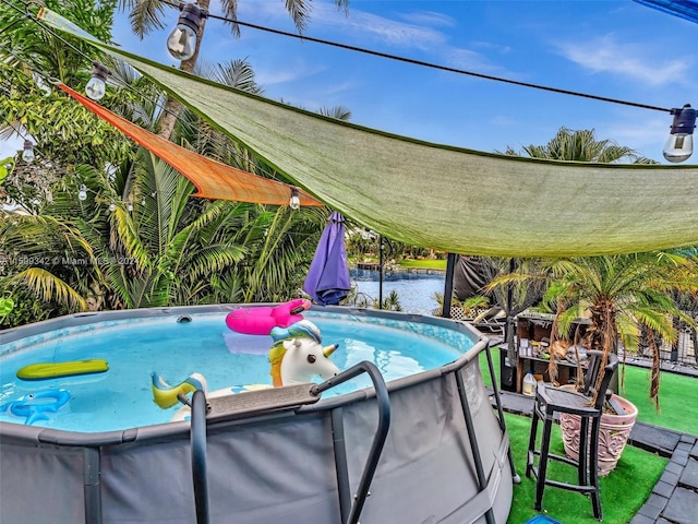 view of swimming pool with a water view