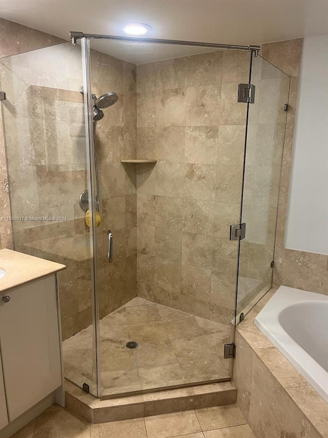 bathroom with vanity, shower with separate bathtub, and tile patterned flooring