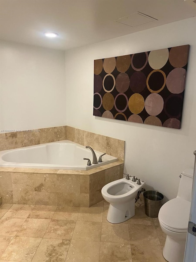 bathroom with a bidet, toilet, and tile patterned floors