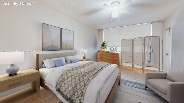 bedroom featuring a textured ceiling, light parquet floors, and ceiling fan