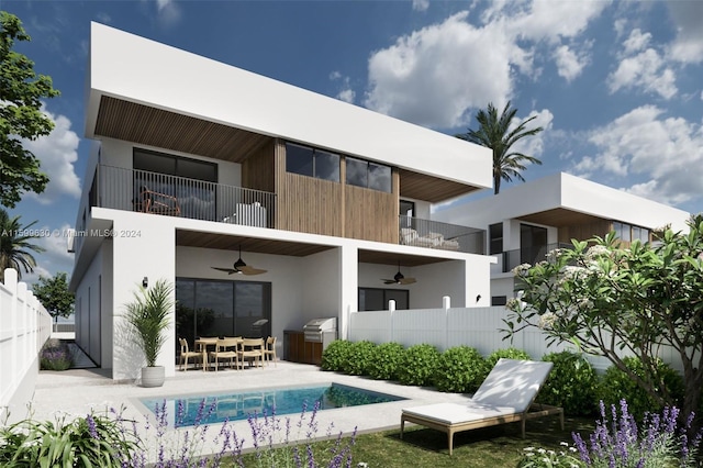 rear view of property with a balcony, ceiling fan, and a patio area