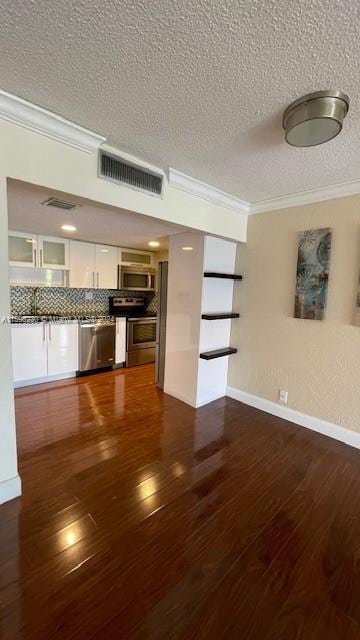 unfurnished living room with crown molding, dark wood-type flooring, and a textured ceiling