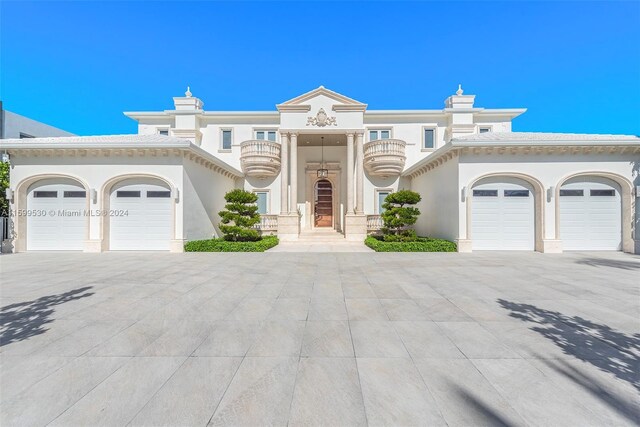 view of front of house with a garage and a balcony