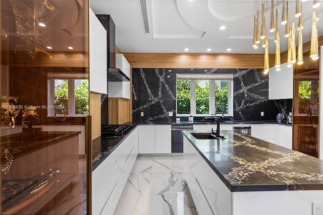 kitchen featuring stainless steel dishwasher, pendant lighting, black gas cooktop, white cabinetry, and a large island