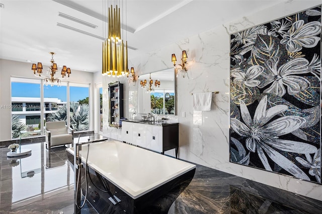 kitchen featuring pendant lighting, sink, tile walls, and an inviting chandelier