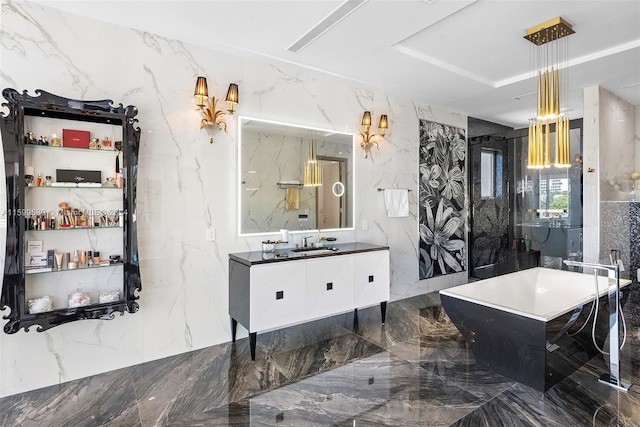 bathroom featuring a bathing tub, vanity, and tile walls