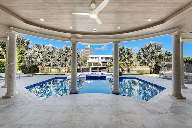 view of pool with ceiling fan and a patio area