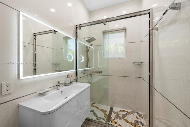 bathroom featuring vanity and a shower with shower door