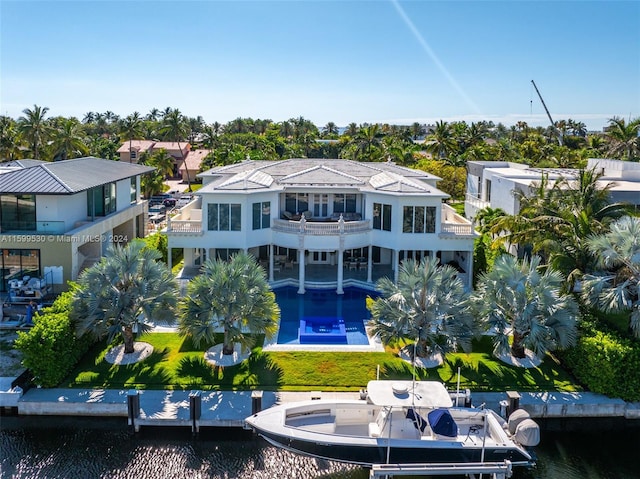 back of house with a balcony and a water view