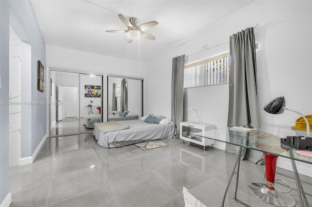 bedroom with multiple closets and ceiling fan