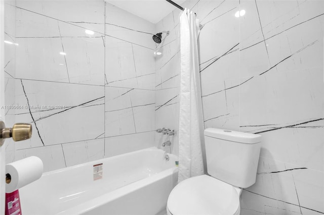 bathroom with tile walls, toilet, and shower / bath combination with curtain