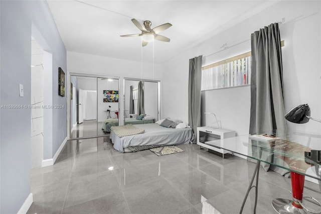 bedroom with multiple closets and ceiling fan