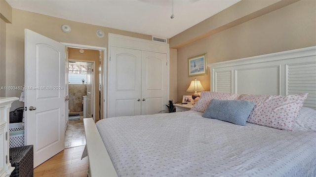 bedroom featuring a closet and light hardwood / wood-style flooring