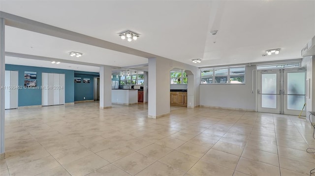 interior space featuring light tile patterned floors and french doors