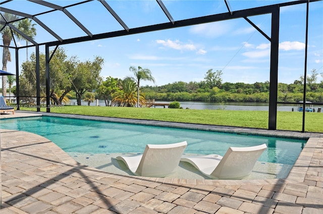 view of swimming pool featuring glass enclosure, a patio area, a water view, and a yard